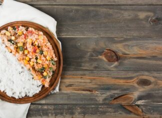 Куриный плов с рисом в кастрюле на плите